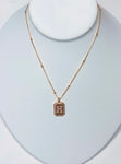 Photo of a rhinestone initial necklace on a 16 inch gold filled chain