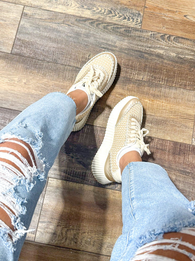 Photo of a pair of vegan, platform gold & beige sneakers with a woven knit detail