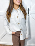 woman wearing beige and white gingham long sleeve button down shacket