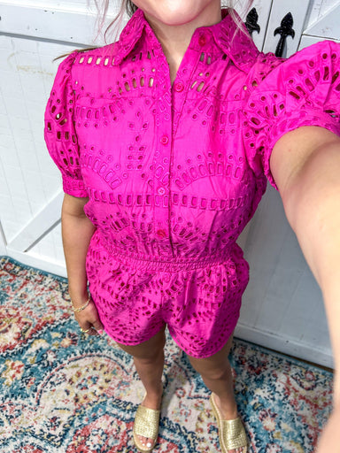 Woman modeling an up close photo of the all over eyelet detail on the romper