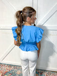 Woman modeling the back of our azure blue short sleeve blouse