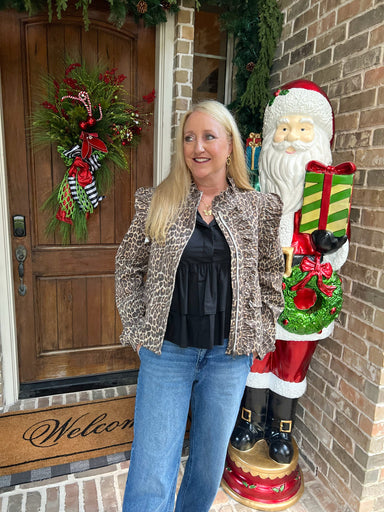 Woman modeling a long sleeve denim jacket in a leopard print with ruffle details