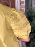 Up close photo of the sleeve with intricate arm design worn by a person, outdoors.