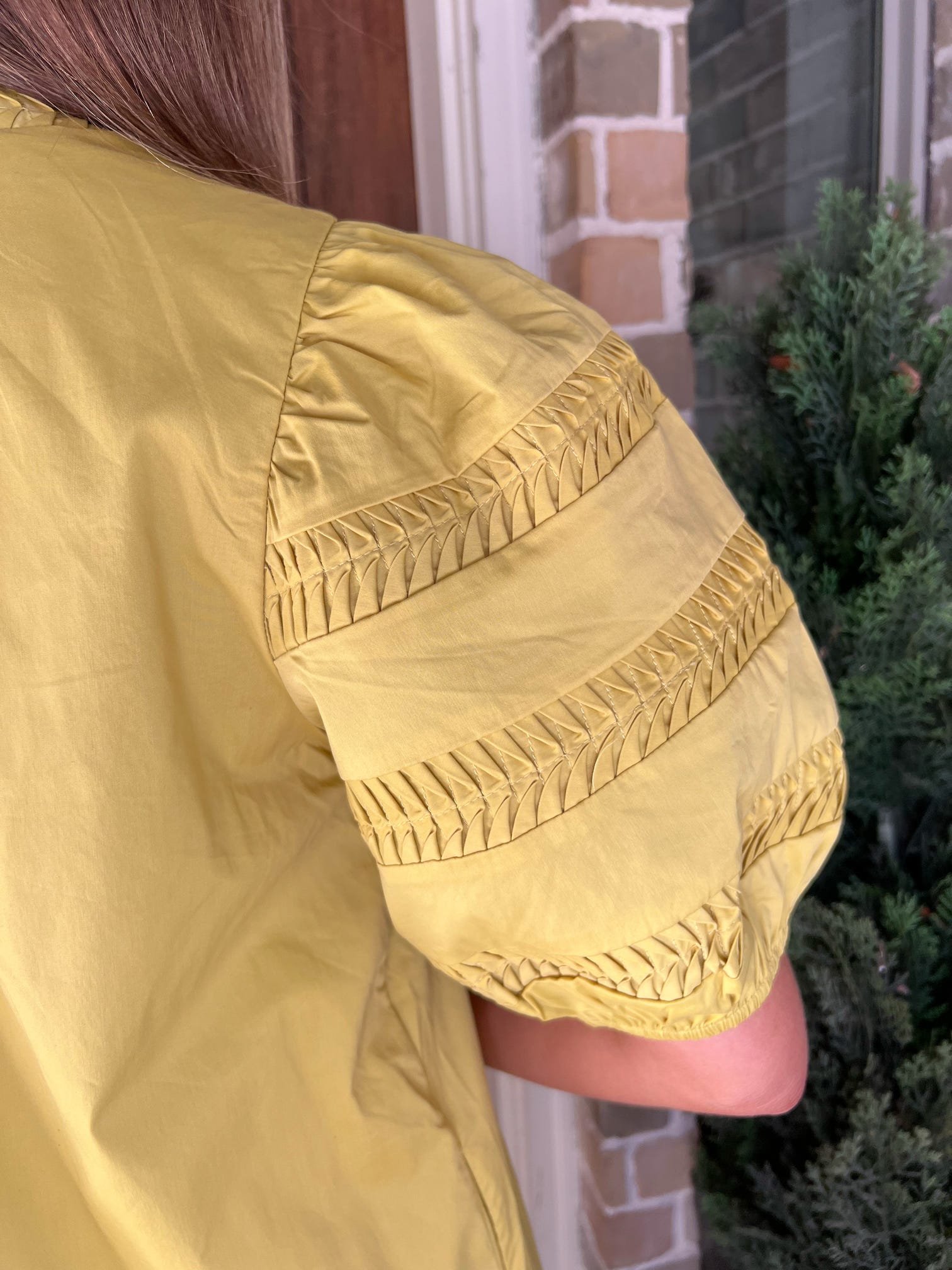 Up close photo of the sleeve with intricate arm design worn by a person, outdoors.