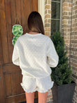 Photo of the back of this cream with khaki polka dots long sleeve and matching shorts set