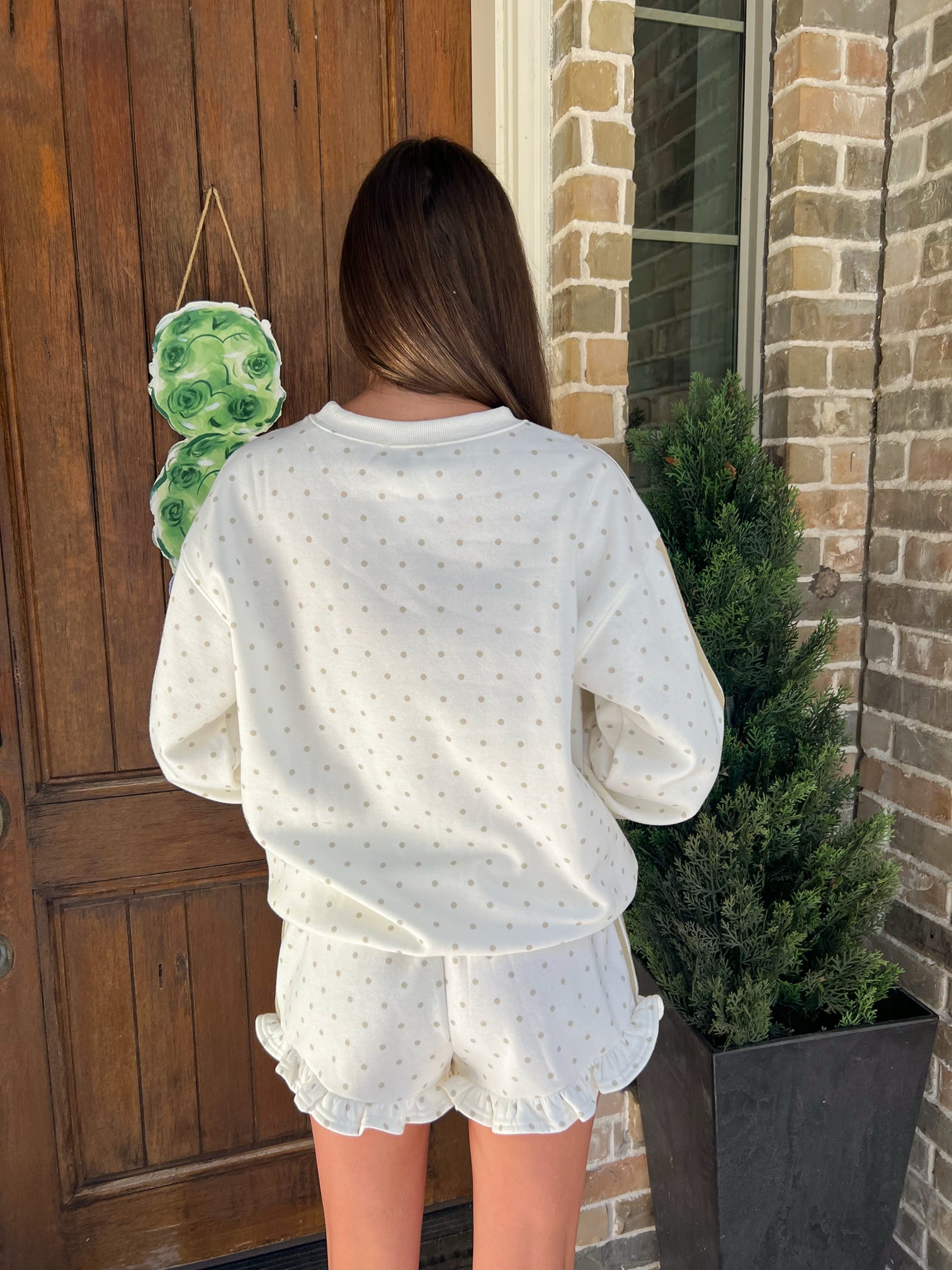 Photo of the back of this cream with khaki polka dots long sleeve and matching shorts set