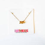 A gold chain necklace with a 3D metallic 'EEE' pendant, displayed on a white card with the brand name 'DUOTHREADS' printed in red and black.