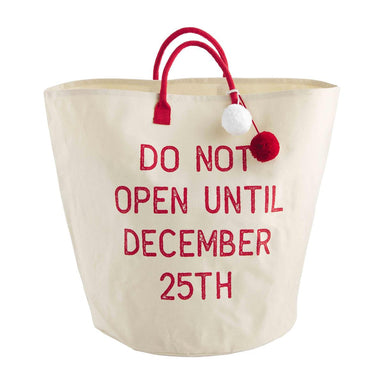 Photo of a Large canvas tote features cotton webbing handles with yarn poms saying Do Not Open Until December 25th