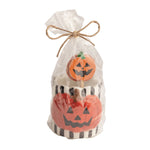A black and white with an orange pumpkin ceramic toothpick holder with 6 pumpkin cardstock toppers on toothpicks in a clear bag with a decorative bow on a white background