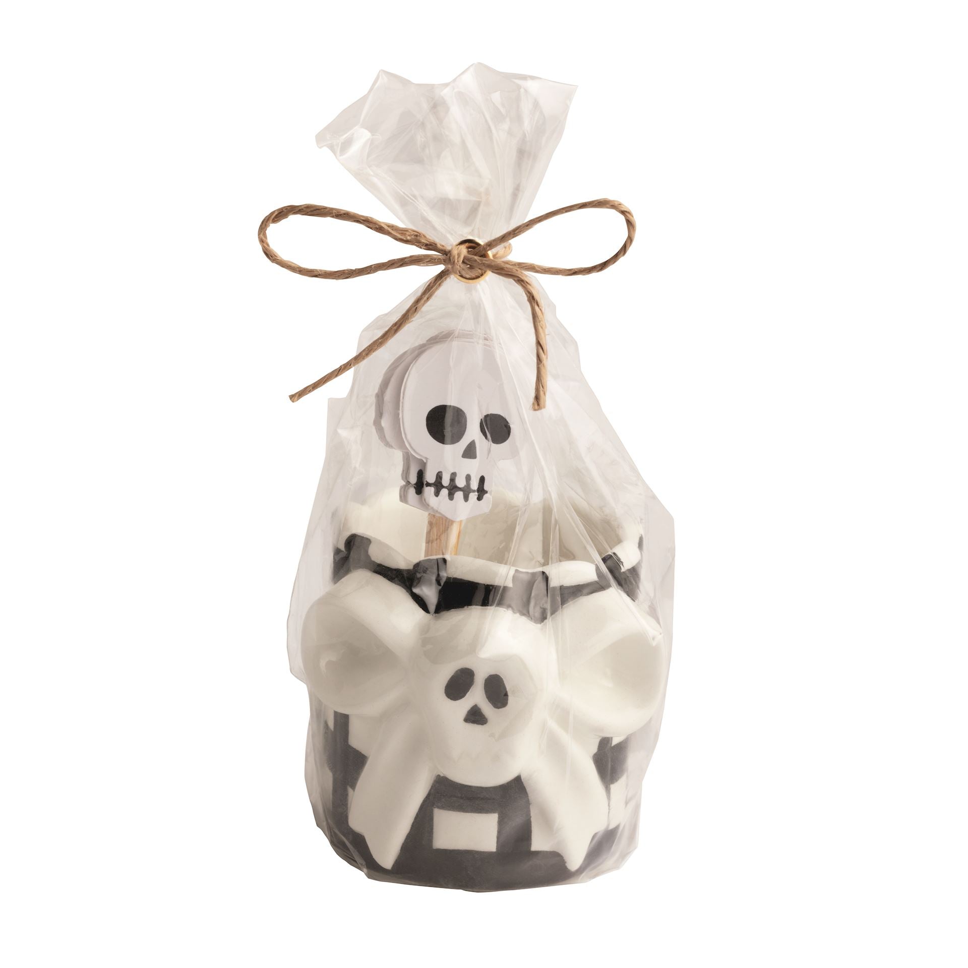 A black and white with a bow-shaped skull ceramic toothpick holder with 6 skull cardstock toppers on toothpicks in a clear bag with a decorative bow on a white background