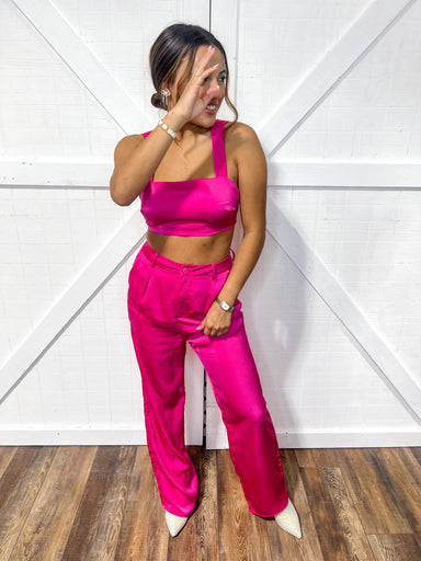 Magenta colored matching top and bottom set featuring a crop top and flowy pants