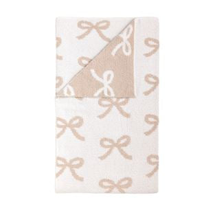 White and beige chenille knit blanket featuring an all-over bow pattern