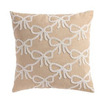 Beige pillow with white bow pattern on a beige background