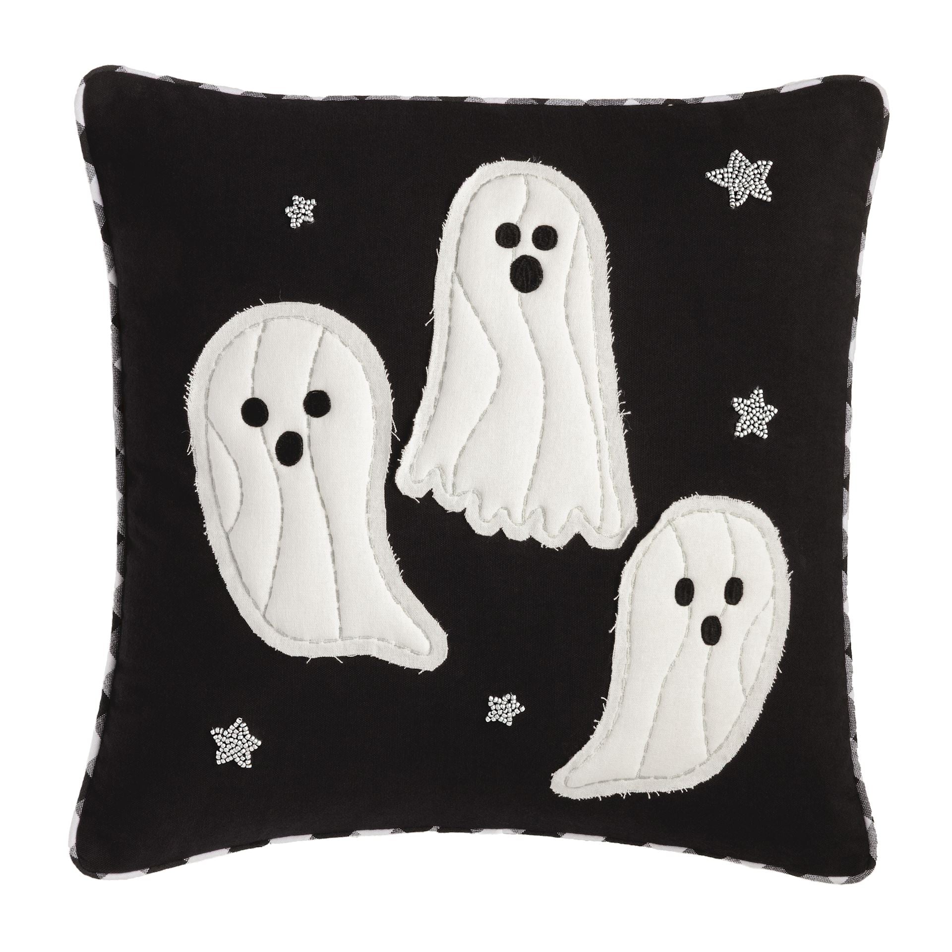 Black pillow with white ghost designs and star patterns on a white background