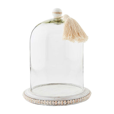 Photo of a glass cloche featuring white mango wood top handle with tassel and beaded white mango wood base