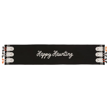 A black Halloween-themed runner or banner with 'Happy Haunting' written in white script across the center, decorated with cartoon ghosts and orange pumpkins on both ends.