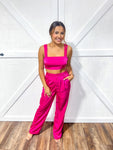 Magenta colored matching top and bottom set featuring a crop top and flowy pants 