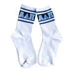 A pair of white crew socks with navy and light blue stripes at the cuff, featuring the Greek letters Alpha Delta Pi (ΑΔΛ) in light blue on the front. The word 'DUO' is printed in light blue on the toes.