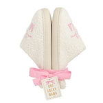 Pair of white slippers with rubber bottom that says Mama with a bow on the top in light pink