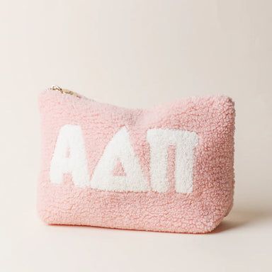 Pink fluffy pouch with white sorority letters saying ADPi on a light beige background