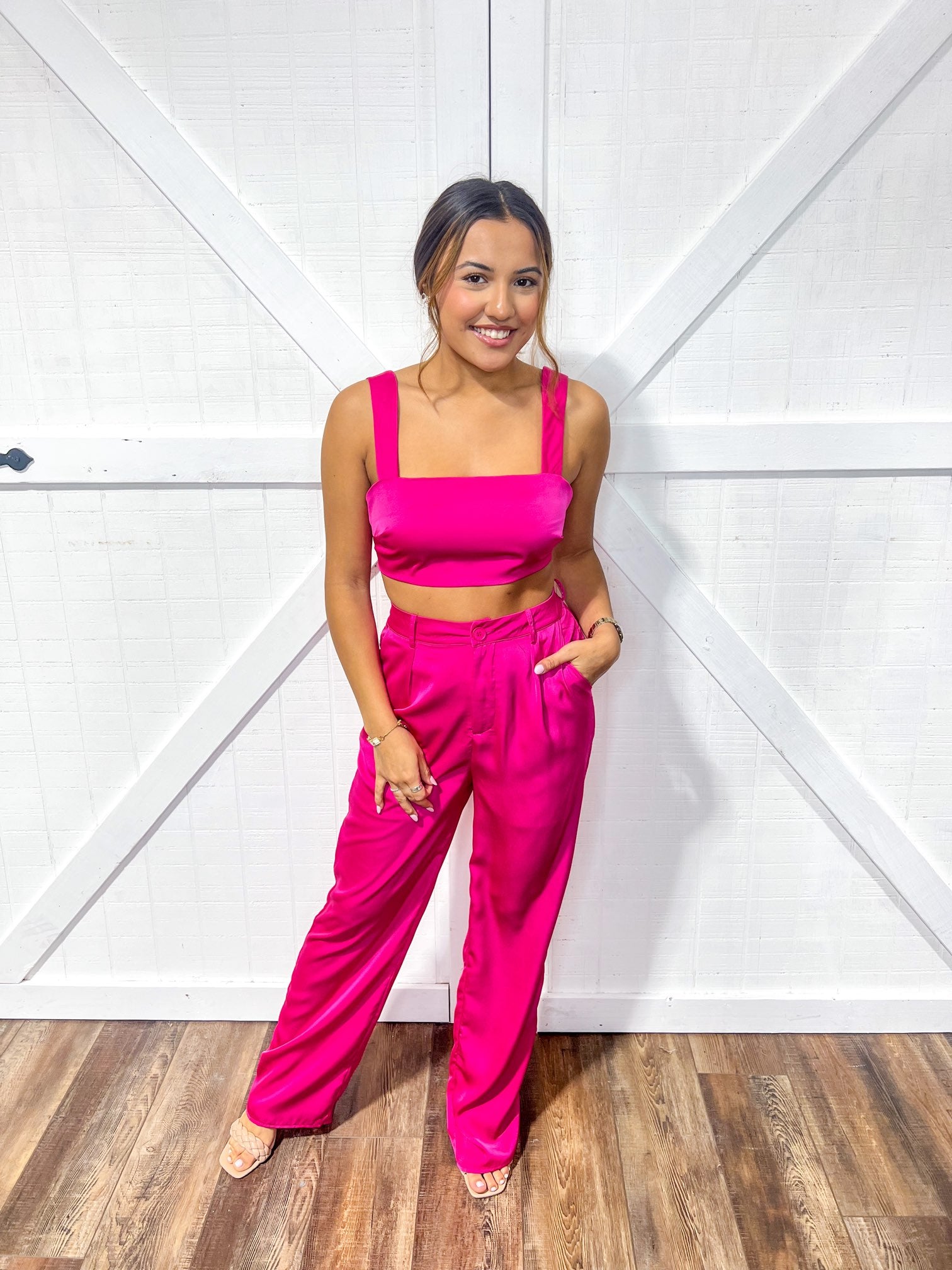 Magenta colored matching top and bottom set featuring a crop top and flowy pants