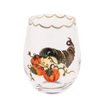 Decorative stemless wine glass with pumpkins and a cornucopia on a white background