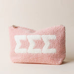 Pink fuzzy pouch with white sorority letters saying Sigma Sigma Sigma on a light pink background