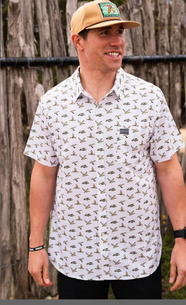 Man modeling the front of our short sleeve button up shirt with an all over print of Mallard ducks and a chest pocket