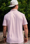 Man modeling the back of our white short sleeve polo with an all over pattern of orange shapes of the state of Texas