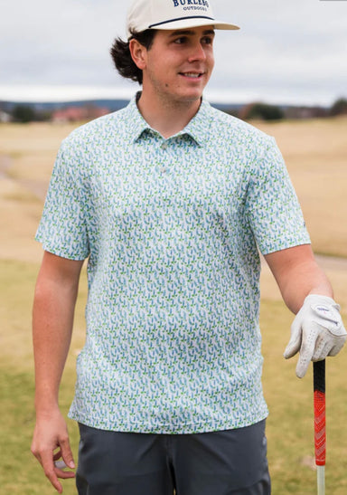Man modeling the front of our white, short sleeve, performance polo with little bluebonnets all over