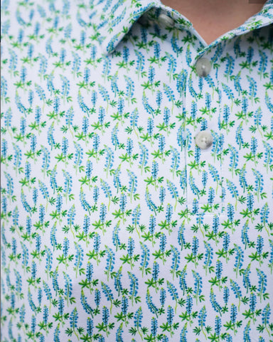 Up close photo of the little bluebonnets all over pattern of the white short sleeve shirt