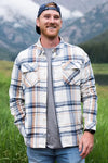 Man wearing a cream plaid long sleeve flannel shirt