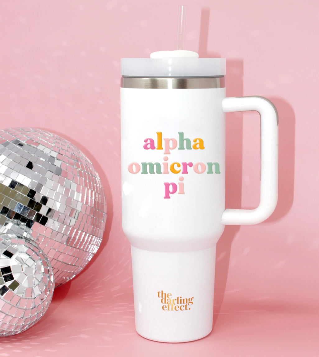 40 oz tumbler with Alpha Omicron Pi on it in a light and dark pink, orange, and green