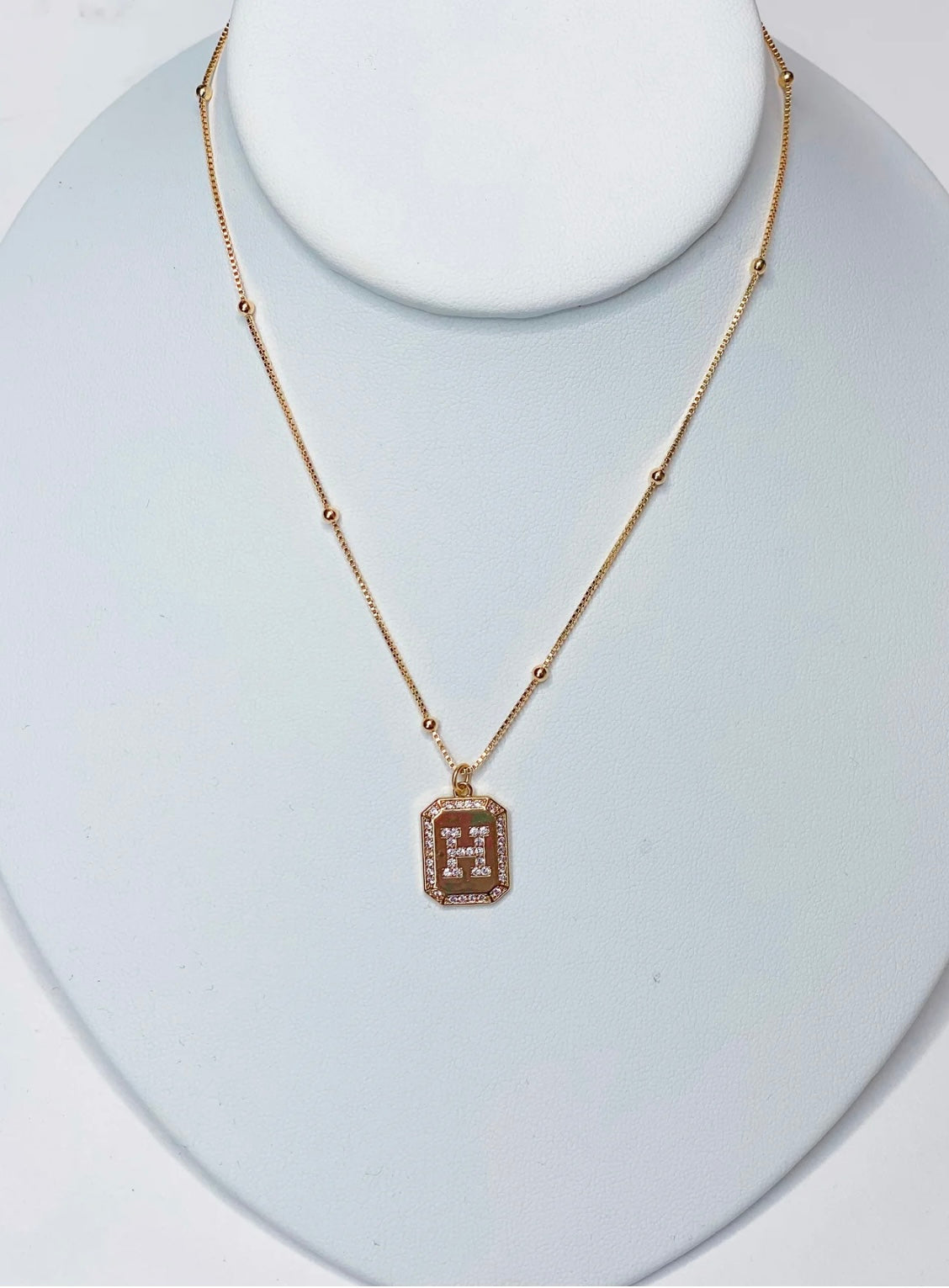 Photo of a rhinestone initial necklace on a 16 inch gold filled chain