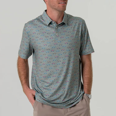A man wearing a grey short sleeve polo with small red, yellow and blue Broncos in an all over pattern 