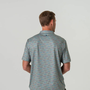 A man modeling the back of a grey short sleeve polo with small red, yellow and blue Broncos in an all over pattern 