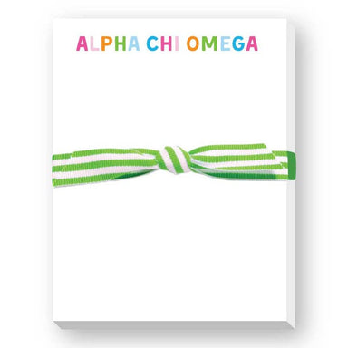 A white rectangular box or package with the words “ALPHA CHI OMEGA” printed across the top in multicolored letters, tied with a green and white striped ribbon bow, shown on a white background.