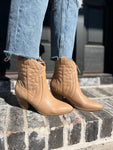Another photo of a woman modeling our toffee-colored western booties