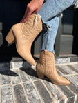 Photo of a woman modeling our toffee-colored western booties