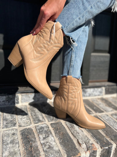 Photo of a woman modeling our toffee-colored western booties